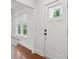 Bright entryway with hardwood floors, a white front door with window, and natural light at 1989 Nitsa St, Johns Island, SC 29455