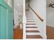 Inviting entryway featuring hardwood floors, a staircase with wood railing, and white walls at 1989 Nitsa St, Johns Island, SC 29455
