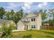 Charming two-story home with a well-manicured lawn and attached garage, surrounded by lush trees at 1989 Nitsa St, Johns Island, SC 29455