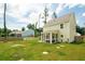 Exterior view of a two-story home with a screened-in porch and a lush lawn at 1989 Nitsa St, Johns Island, SC 29455