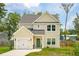 Inviting two-story home features a well-maintained lawn and an attached garage at 1989 Nitsa St, Johns Island, SC 29455