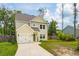 Inviting two-story home features a well-maintained lawn and an attached garage at 1989 Nitsa St, Johns Island, SC 29455