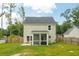 Back exterior of a two-story home with a screened-in porch and a spacious backyard at 1989 Nitsa St, Johns Island, SC 29455