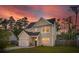 Inviting two-story home featuring a neat, landscaped lawn, an attached garage, and neutral siding at 1989 Nitsa St, Johns Island, SC 29455