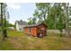 Exterior shot of building in backyard, surrounded by green grass and trees at 1989 Nitsa St, Johns Island, SC 29455
