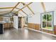 Bright shed interior with wood floors, beamed ceiling, and barn door, providing a cozy feel at 1989 Nitsa St, Johns Island, SC 29455