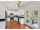 Beautiful kitchen with white cabinets, stainless steel appliances, black counters, and hardwood floors at 1989 Nitsa St, Johns Island, SC 29455