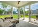 Screened in porch with outdoor sofa, tiled floor, and backyard views at 1989 Nitsa St, Johns Island, SC 29455