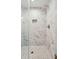 Walk in shower features marble tiling, mosaic tiling in shower floor and shower shelf at 1989 Nitsa St, Johns Island, SC 29455