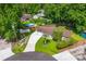Aerial view of landscaped home with long driveway, backyard shed, and above ground pool at 1990 Butternut St, Charleston, SC 29414