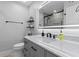 Modern bathroom featuring a marble countertop, stylish vanity, and illuminated mirror at 1990 Butternut St, Charleston, SC 29414
