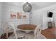 Cozy dining room featuring a round table, four chairs, decorative lighting, and elegant wall decor at 1990 Butternut St, Charleston, SC 29414