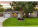 Charming brick home featuring a well-manicured lawn, palm tree, and inviting front porch with seating at 1990 Butternut St, Charleston, SC 29414