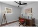 Inviting home office with wooden desk, ceiling fan, and natural light from the window at 1990 Butternut St, Charleston, SC 29414