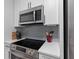 Well-equipped kitchen showcasing stainless steel appliances, white cabinets, and stylish backsplash at 1990 Butternut St, Charleston, SC 29414