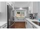 Bright kitchen features stainless steel appliances, white cabinets, and a charming window nook at 1990 Butternut St, Charleston, SC 29414