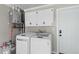 Functional laundry room with modern washer, dryer, and storage cabinets for convenience at 1990 Butternut St, Charleston, SC 29414