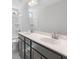 Dual sink bathroom with grey cabinets, a bath and shower combination, and large mirrors at 206 Palfrey Dr, Ridgeville, SC 29472