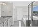 Well-lit bathroom showcasing a double vanity, soaking tub, and tiled shower at 206 Palfrey Dr, Ridgeville, SC 29472