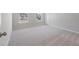 Spacious, light-filled bedroom featuring plush carpeting and two windows at 206 Palfrey Dr, Ridgeville, SC 29472