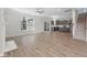 Open-concept living space with wood floors, kitchen, staircase, and large windows at 206 Palfrey Dr, Ridgeville, SC 29472