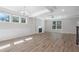 Spacious living room with a fireplace, ceiling fan, ample natural light, and wood flooring at 206 Palfrey Dr, Ridgeville, SC 29472