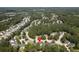 Expansive aerial view of a vibrant neighborhood nestled among lush green trees in a quiet suburban community at 207 Breckingridge Dr, Ladson, SC 29456