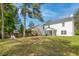 Spacious backyard featuring a well-manicured lawn, mature trees, and a view of the home's exterior at 207 Breckingridge Dr, Ladson, SC 29456