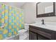 Bathroom featuring a single sink vanity, a wooden framed mirror, and a charming duck-themed shower curtain at 207 Breckingridge Dr, Ladson, SC 29456