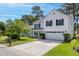 Charming two-story home boasts a manicured front lawn and inviting curb appeal at 207 Breckingridge Dr, Ladson, SC 29456