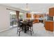 Spacious eat-in kitchen features wood cabinets, granite counters, stainless appliances, and a sliding glass door to the backyard at 207 Breckingridge Dr, Ladson, SC 29456
