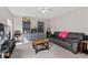 Comfortable living room with a cozy couch, built-in bookshelves, TV, and ample seating for entertaining guests at 207 Breckingridge Dr, Ladson, SC 29456