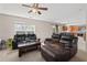 Open-concept living room features plush leather seating, a wooden coffee table, and an adjacent kitchen area at 207 Breckingridge Dr, Ladson, SC 29456