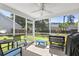Cozy screened-in porch featuring comfortable seating, ceiling fan, and views of the backyard at 207 Breckingridge Dr, Ladson, SC 29456
