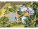 Aerial view of community amenities including a pool, tennis courts, and clubhouse nestled in lush greenery at 226 Old House Ln, Dewees Island, SC 29451