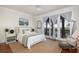 This charming bedroom features hardwood floors, ceiling fan, and access to the balcony at 226 Old House Ln, Dewees Island, SC 29451
