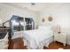 This lovely bedroom features a ceiling fan, hardwood floors, and views of the ocean at 226 Old House Ln, Dewees Island, SC 29451