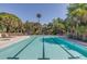Inviting community pool area with palm trees and comfortable lounge chairs for relaxing and enjoying the sun at 226 Old House Ln, Dewees Island, SC 29451