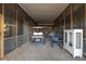 Screened in garage featuring golf cart, cabinet, and ample storage space at 226 Old House Ln, Dewees Island, SC 29451