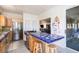 Bright kitchen with a tiled island, stainless steel appliances, and a view to the living area at 226 Old House Ln, Dewees Island, SC 29451