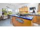 Charming kitchen with tiled countertops, stainless steel appliances, and ample natural light at 226 Old House Ln, Dewees Island, SC 29451