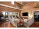 Spacious living room with wood walls and ceiling, large windows, and waterfront views at 226 Old House Ln, Dewees Island, SC 29451