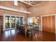 Open living space with natural light, vaulted ceilings, a dining table, and wood floors at 226 Old House Ln, Dewees Island, SC 29451