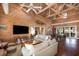 Inviting living room showcasing wooden floors, beamed ceilings, comfortable sofas and an open layout at 226 Old House Ln, Dewees Island, SC 29451