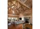 Spacious living room featuring a vaulted ceiling, wooden floors, comfortable seating and views of the outdoors at 226 Old House Ln, Dewees Island, SC 29451