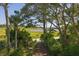 Inviting path leading to the home, nestled among trees with a glimpse of scenic marsh views at 226 Old House Ln, Dewees Island, SC 29451