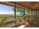 Inviting porch offers a relaxing spot with seating and serene marsh views from this coastal home at 226 Old House Ln, Dewees Island, SC 29451