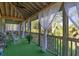 Relaxing screened porch with cozy seating, lush greenery, and an inviting outdoor atmosphere at 226 Old House Ln, Dewees Island, SC 29451