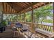 Enjoy relaxing on this inviting porch with scenic views of the surrounding marshland and trees at 226 Old House Ln, Dewees Island, SC 29451