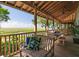 Cozy porch with comfortable seating and views of scenic marshland, perfect for relaxation at 226 Old House Ln, Dewees Island, SC 29451